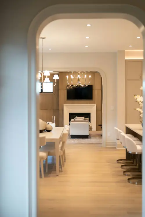 A plaster archway framing a pale oak hallway