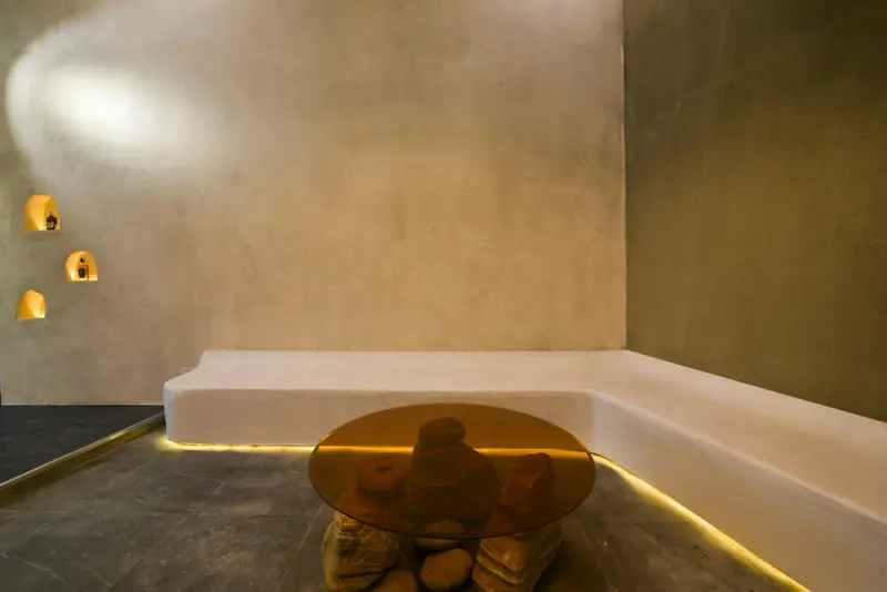 A plaster bench and warm, low lighting in a quiet room