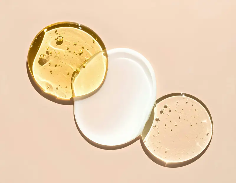 Three pools of clear and amber serum overlapping